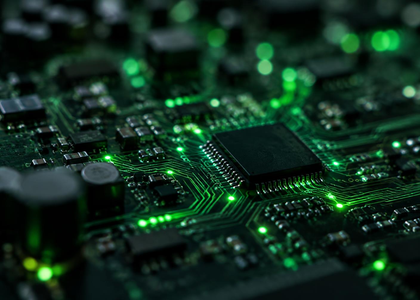 Close-up of a circuit board with glowing green traces